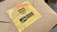 Cheese share box closed with custom logo tape.