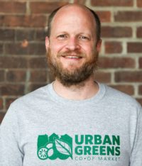Philip Trevvett portrait in Urban Greens logo tee